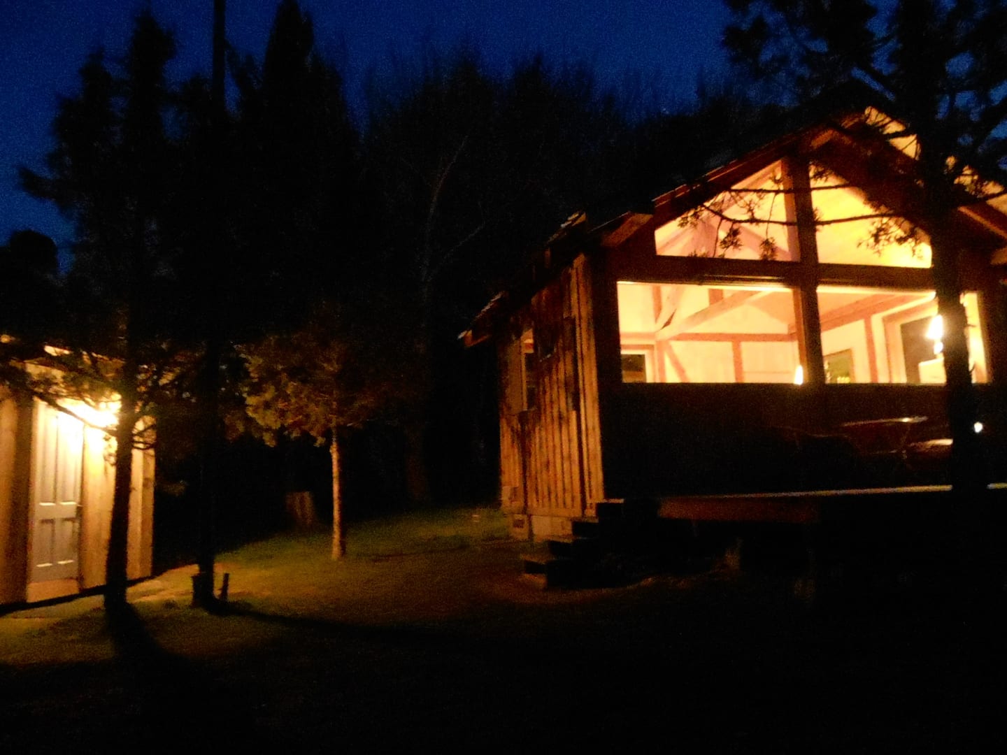Cabin at night with lights on inside