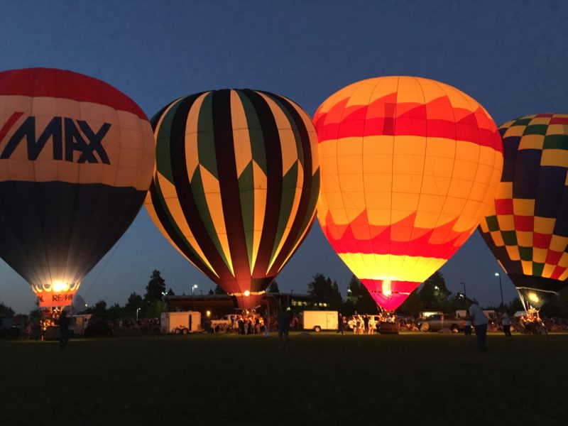 Hot air balloons lit up at night in Redmond Oregon