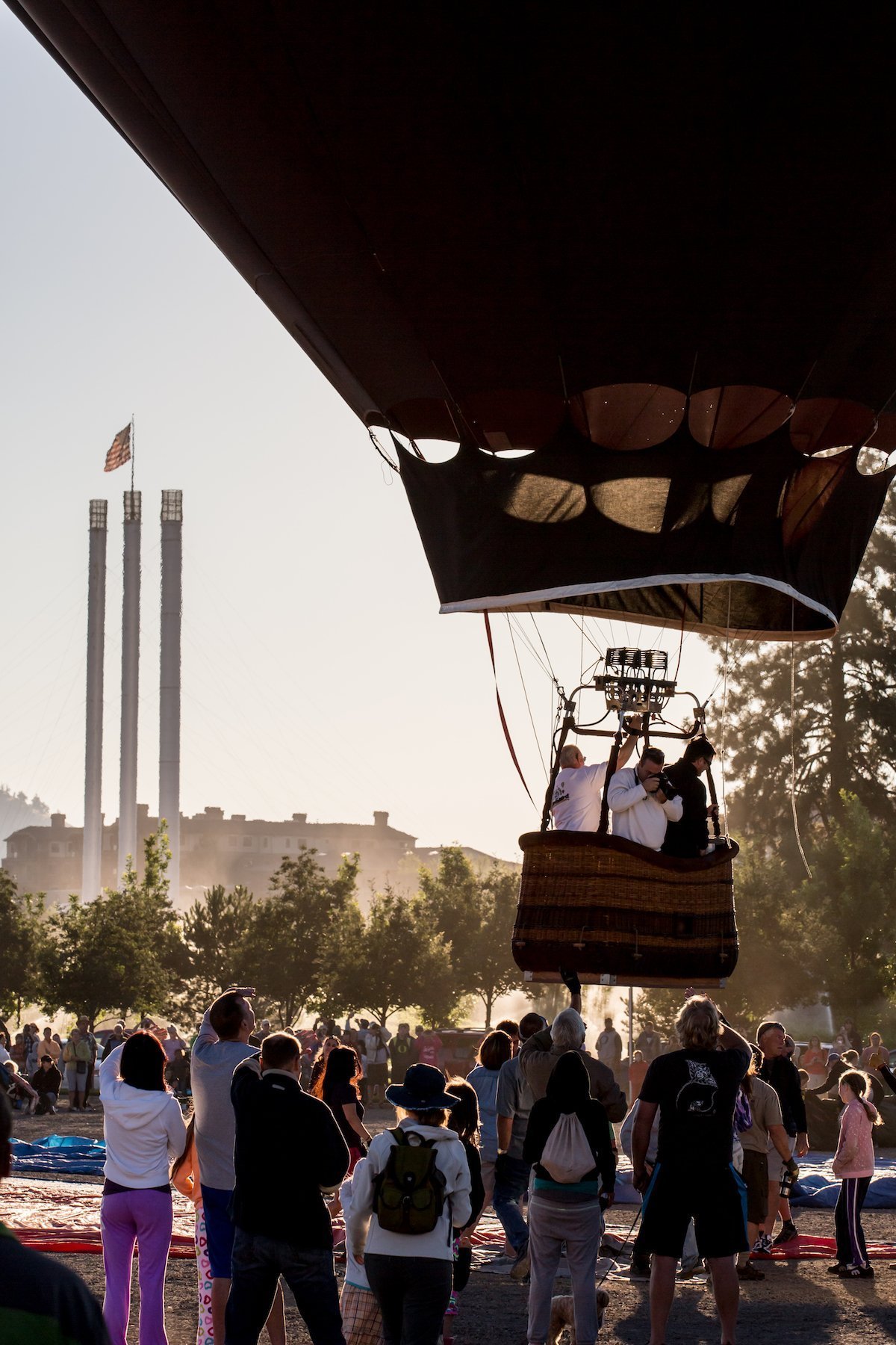 A hot air balloon lifting off in Bend Oregon over the Old Mill District