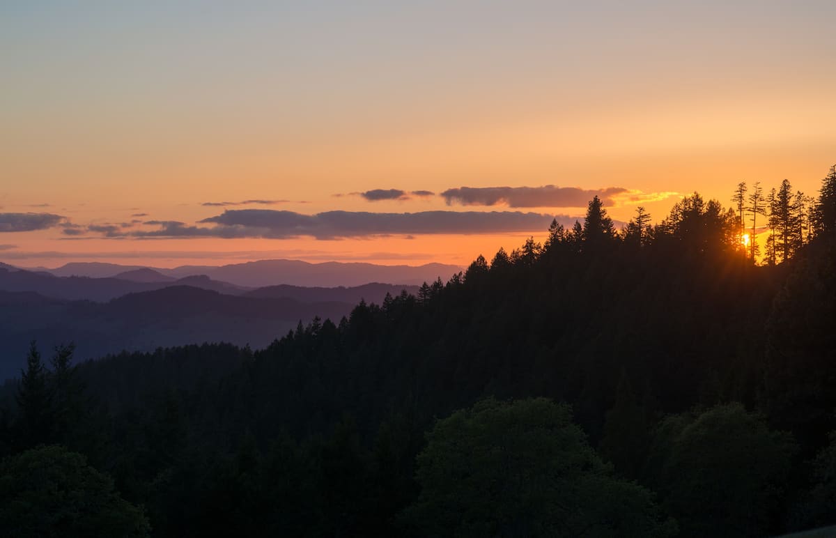 A great sunset view from the lookout tower over the silhouette of mountains and forests