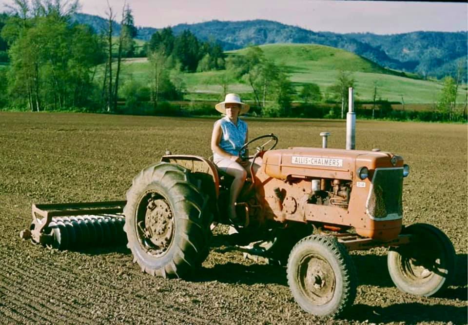 nancy scott on a tractor in scoggins valley oregon