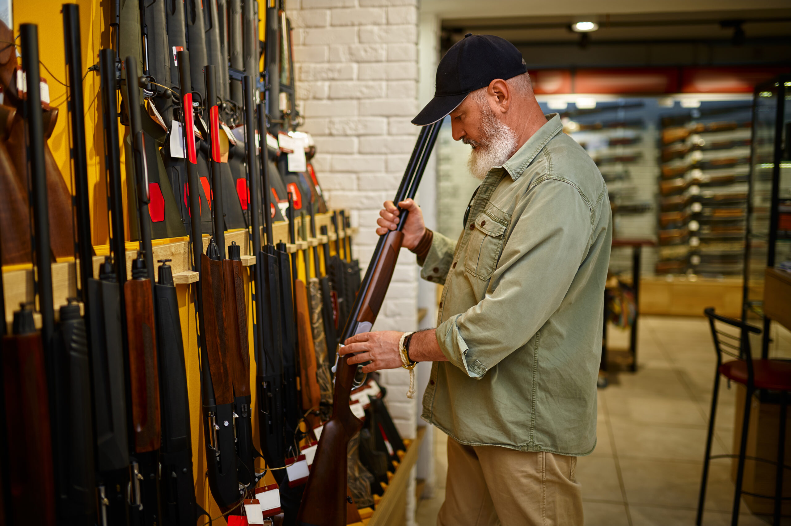 A man looking at guns at a firearm store. Oregon gun control laws 2022, 2023.