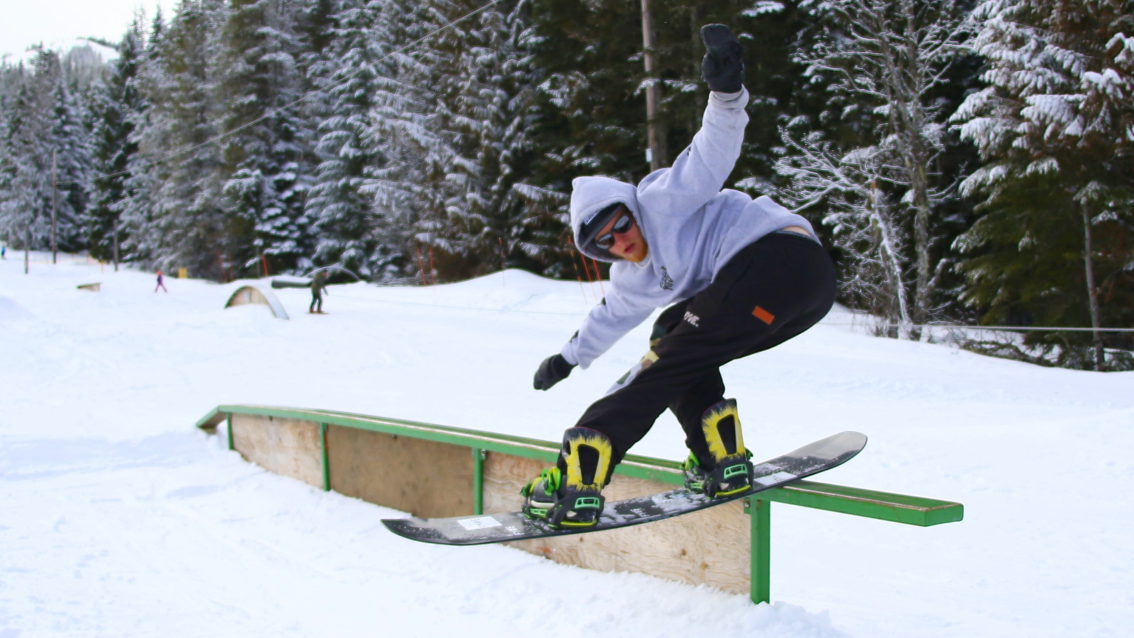 A snowboarder grinding a rail at Ski Bowl.