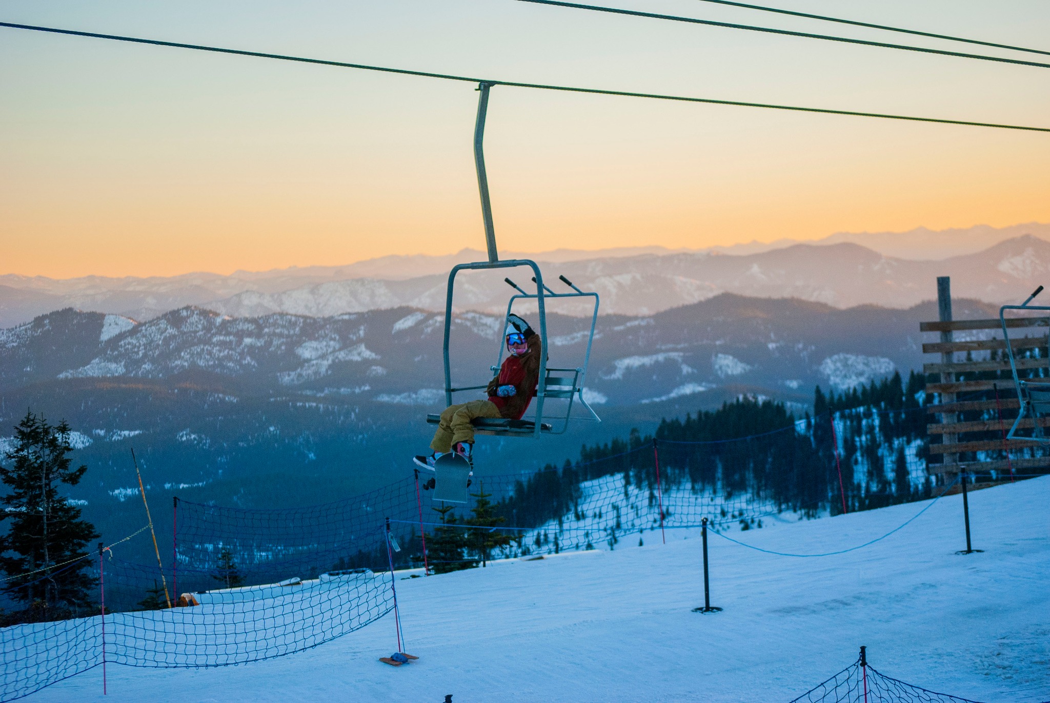 A person rides a chair lift at Mount Ashland.