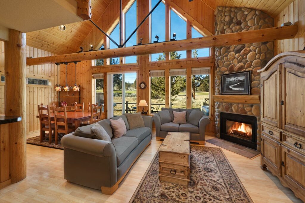 A lodge with lots of wood and a rock fireplace.