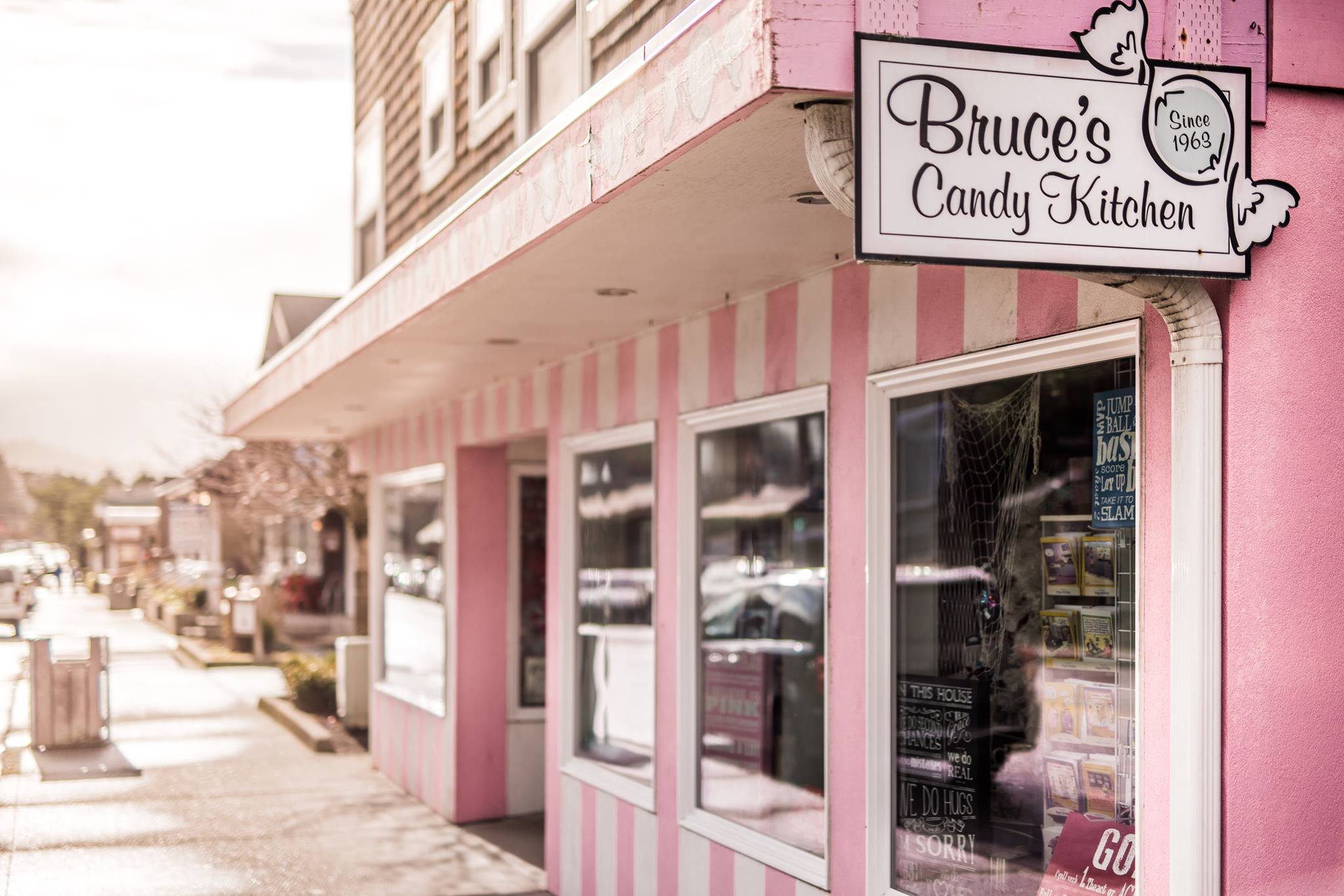 The pink and white striped exterior of Bruce's Candy Kitchen in Cannon Beach Oregon.