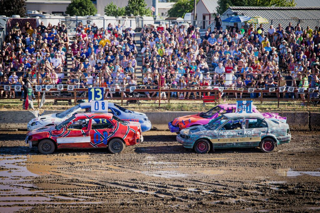 Colorful red and blue cars participating in the demolition derby.