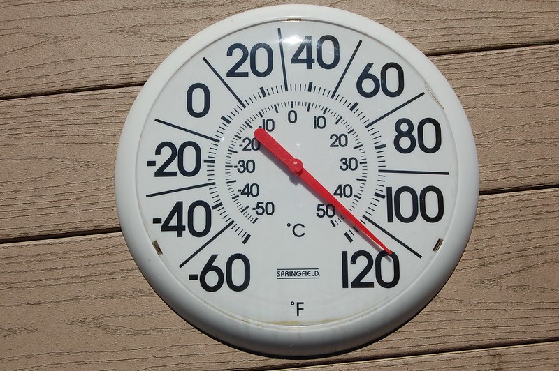 A thermometer shows 115 degrees Fahrenheit.