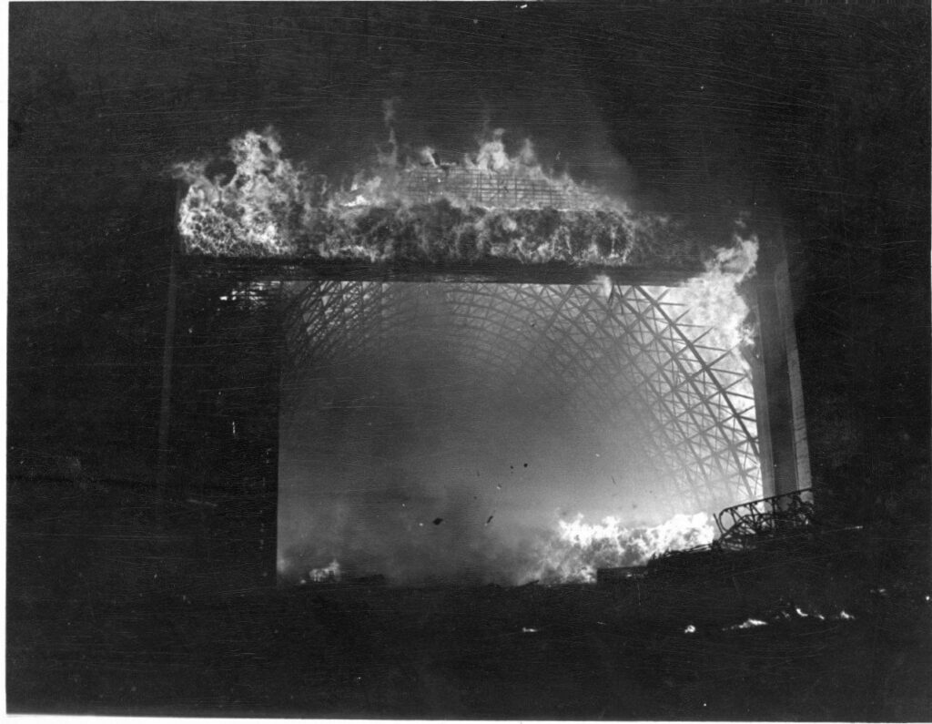 A black and white photo of massive Hangar A burning down at night in 1992. tillamook air museum, planes, WWII, history, family things to do, oregon coast