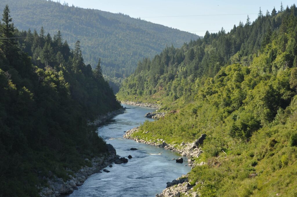 The Klamath River flowing through a forested ravine.