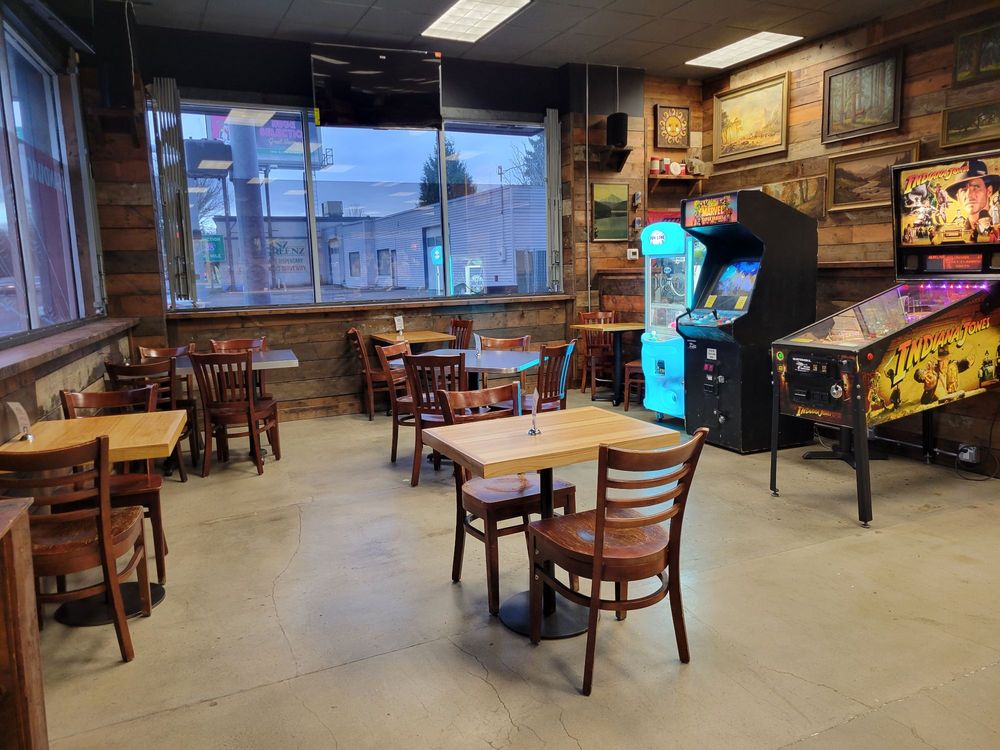 The interior of Sandy-O's. There is wood paneling on the walls, and arcade machines against one wall.