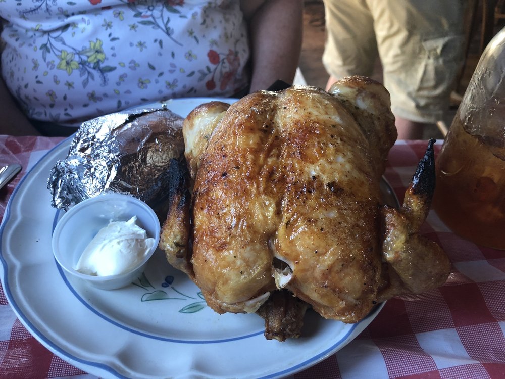 A whole chicken and a baked potato.