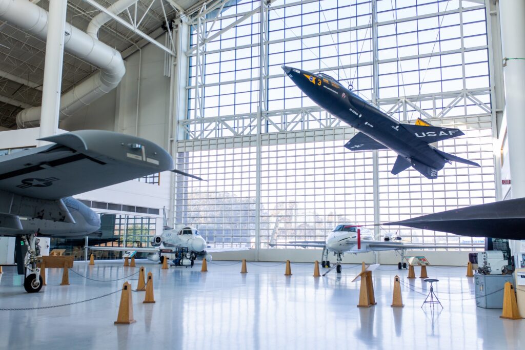 Planes hang from the ceiling and sit on the floor in front of massive windows at the Evergreen Aviation And Space Museum.