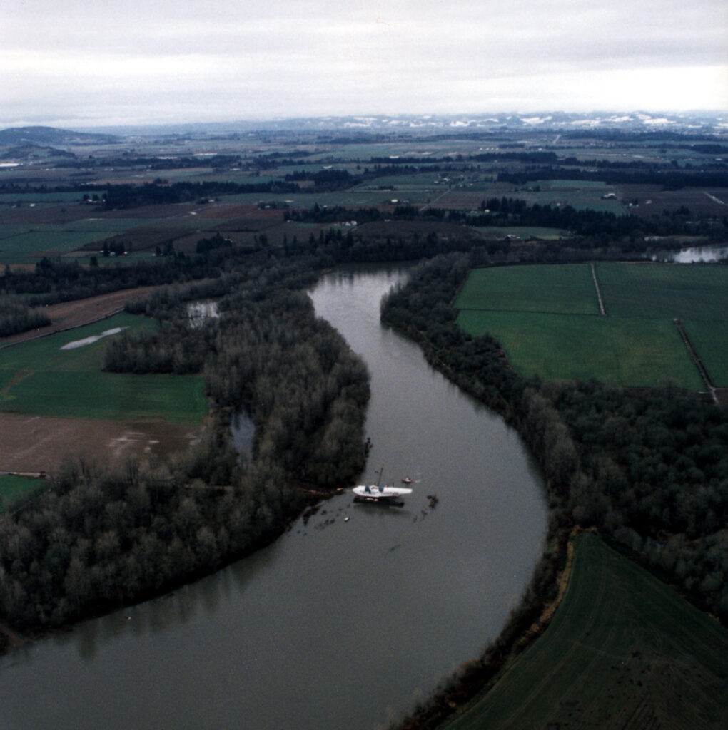 The Spruce Goose being transported in pieces down the river.