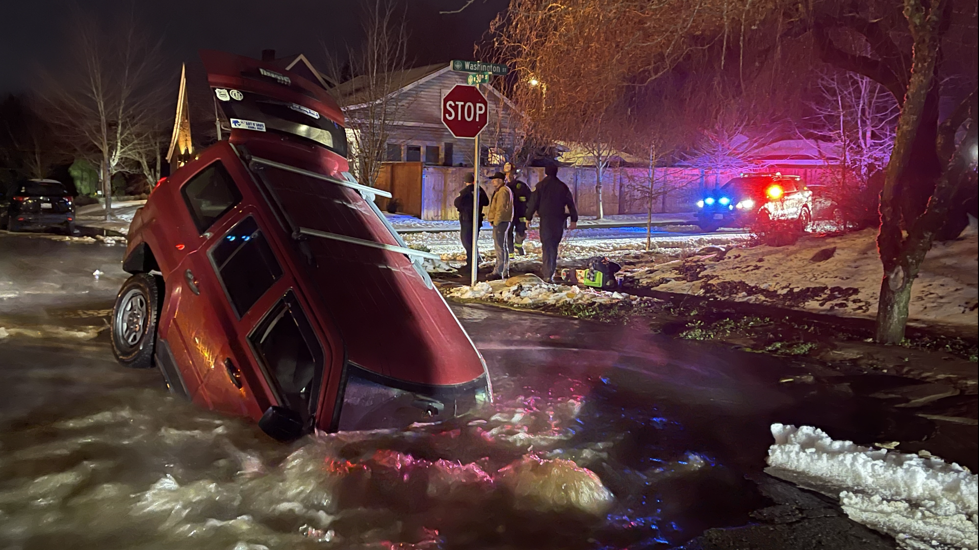 Couple Knee-Deep in Water as Vehicle Plunges into Sinkhole in Washington