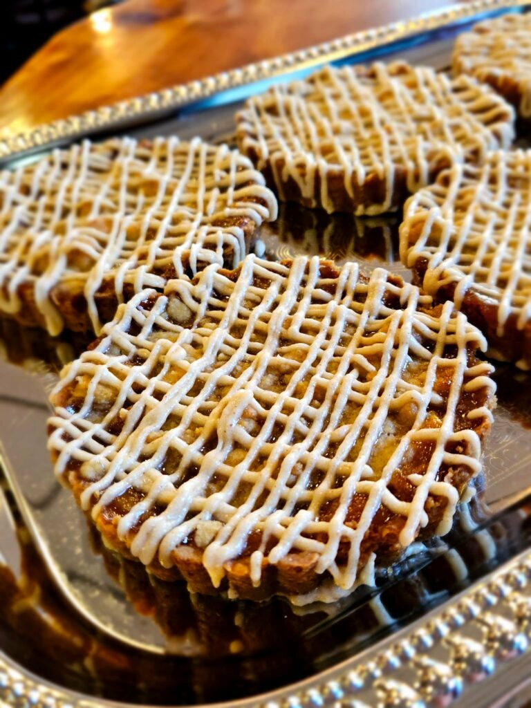 Brown butter peach crumble tart. There's frosting drizzled all over the top and it looks delicious.