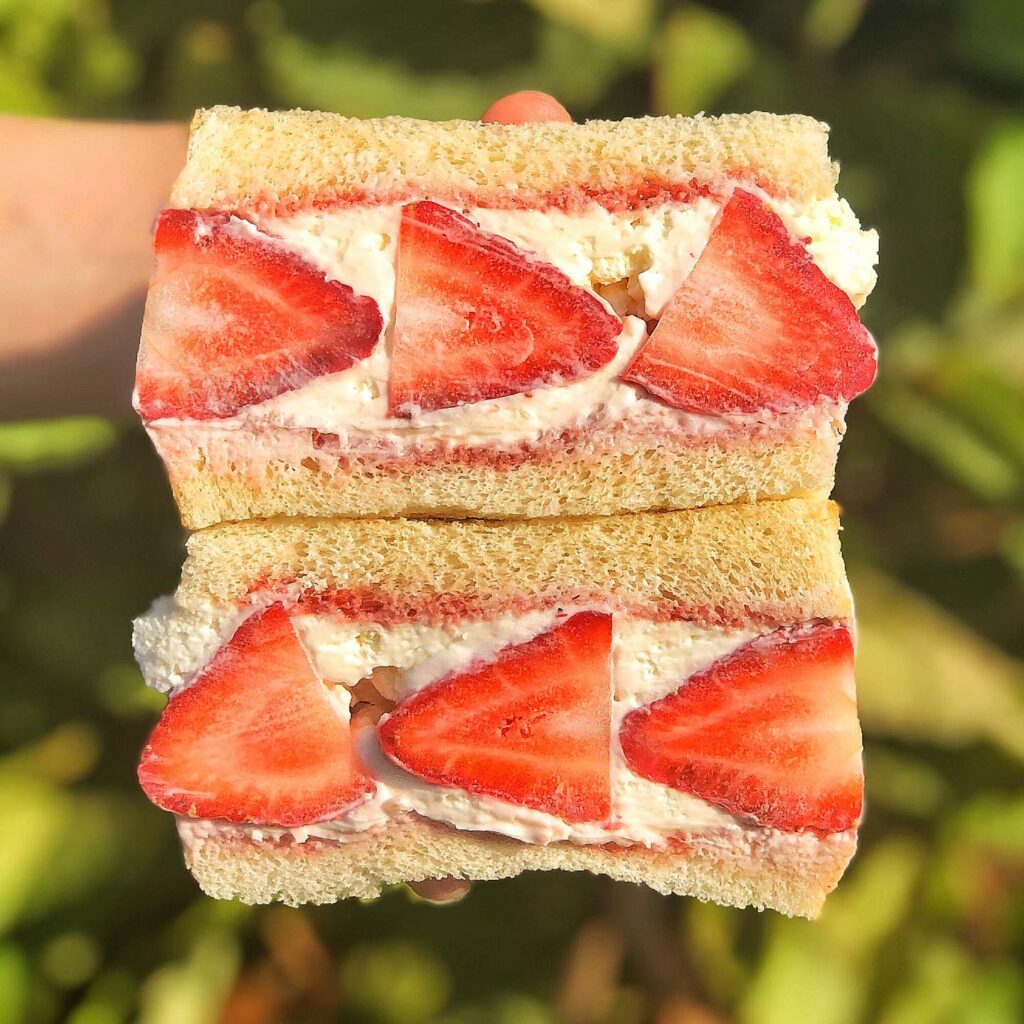 A huge sandwich with strawberries in the middle.  It looks both interesting and delicious!  It's from Tokyo Sando.
portland oregon, best restaurants, 2024, where to eat, best brunch, food and drink, bars, pizza, sushi, thai food, PDX, foodie heaven